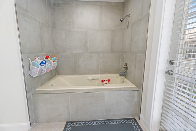 bathroom featuring tile patterned floors and tiled shower / bath