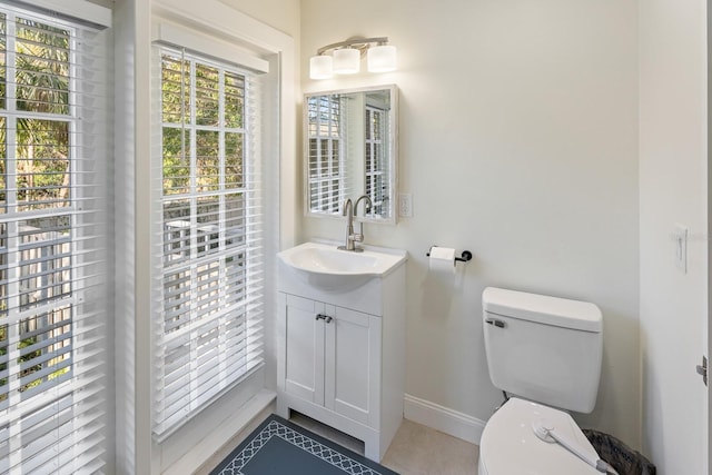 bathroom featuring tile patterned floors, vanity, and toilet