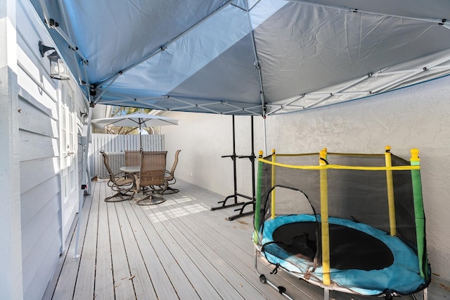 wooden terrace with a trampoline