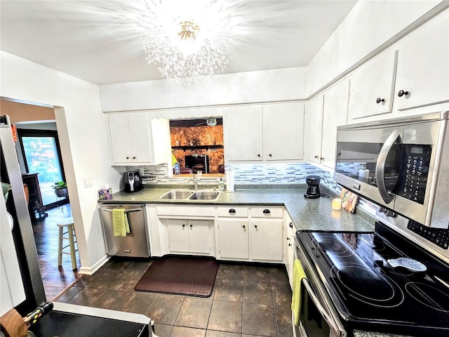 kitchen featuring stainless steel appliances, sink, and white cabinets