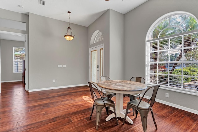 dining area featuring dark wood-type flooring