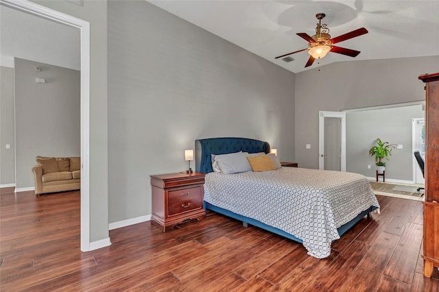 bedroom with lofted ceiling, dark wood-type flooring, and ceiling fan