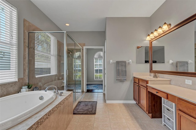 bathroom featuring vanity, plus walk in shower, and tile patterned flooring