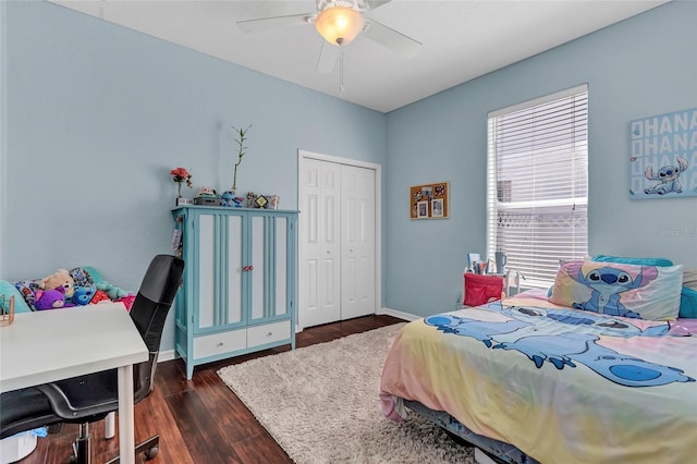 bedroom with dark hardwood / wood-style flooring, a closet, and ceiling fan