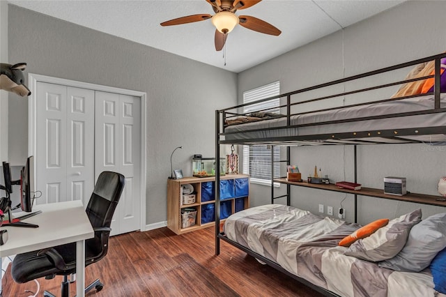 bedroom with ceiling fan, dark hardwood / wood-style flooring, and a closet