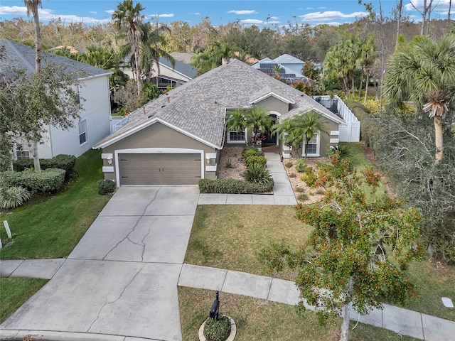 view of front of home with a garage and a front yard