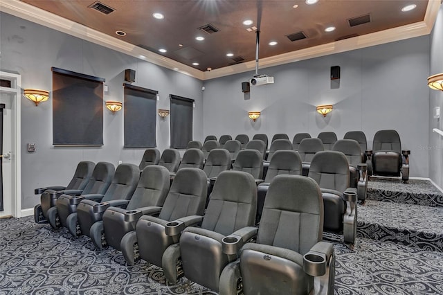 carpeted cinema room featuring crown molding