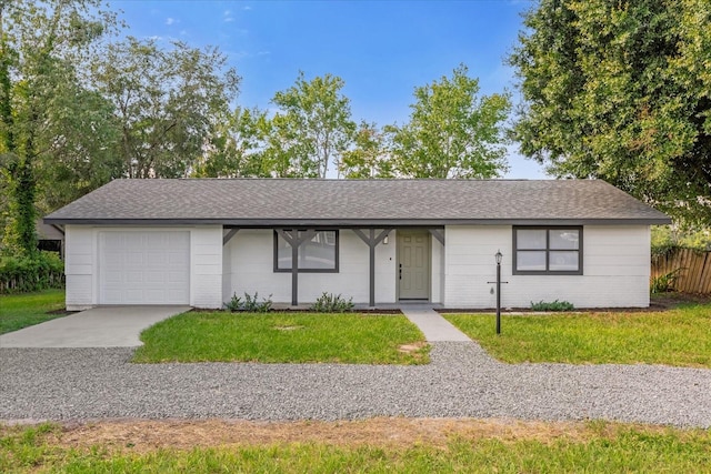 single story home featuring a garage and a front yard