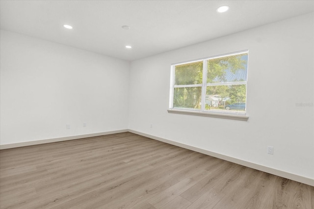 unfurnished room with light hardwood / wood-style floors