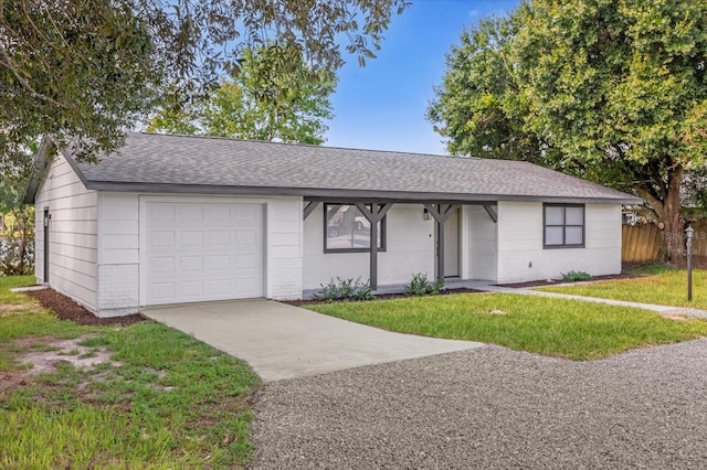 single story home with a garage and a front lawn