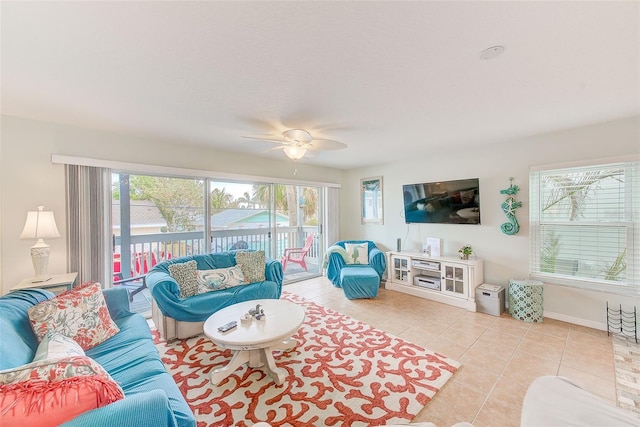 tiled living room with plenty of natural light and ceiling fan