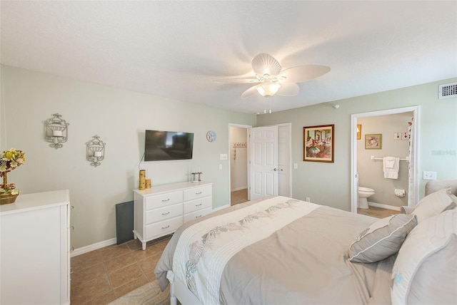 bedroom with baseboards, ceiling fan, ensuite bathroom, and light tile patterned floors