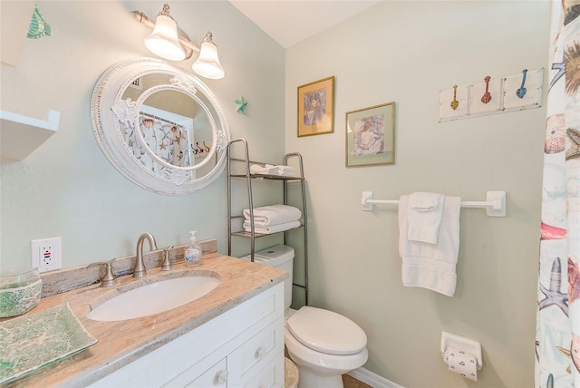 bathroom featuring vanity and toilet