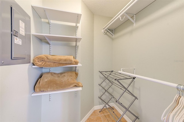 walk in closet featuring tile patterned flooring and electric panel