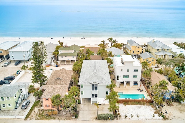 aerial view featuring a water view, a residential view, and a view of the beach