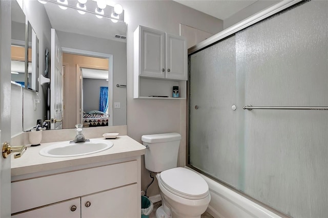 full bathroom with connected bathroom, toilet, vanity, visible vents, and combined bath / shower with glass door