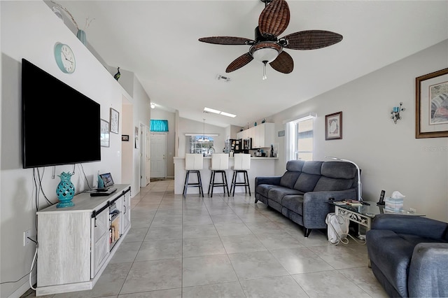 tiled living room with ceiling fan and vaulted ceiling