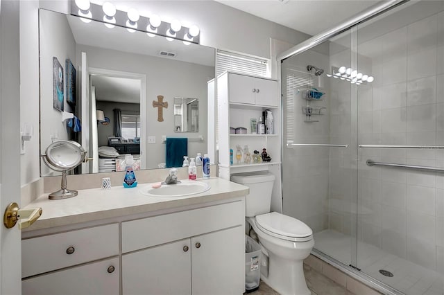 ensuite bathroom featuring a shower stall, visible vents, connected bathroom, and vanity