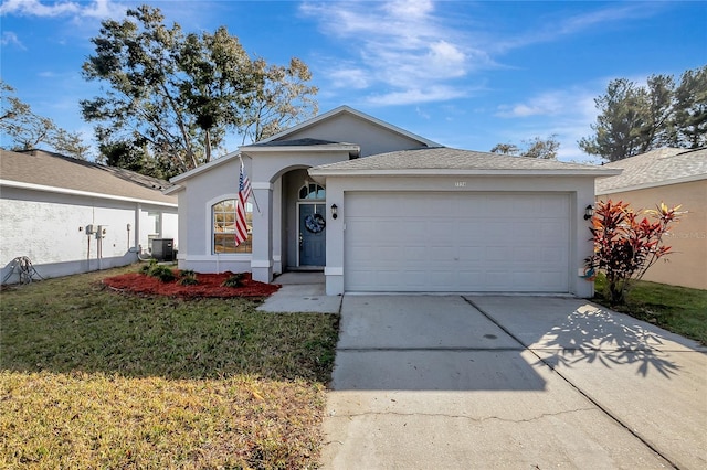 ranch-style home with stucco siding, concrete driveway, an attached garage, cooling unit, and a front lawn