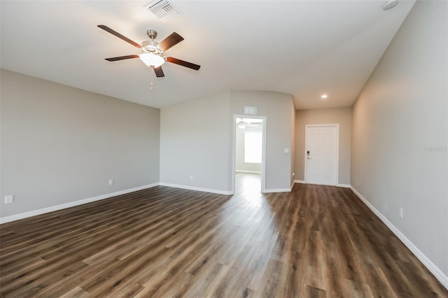 unfurnished living room featuring dark wood-type flooring and ceiling fan