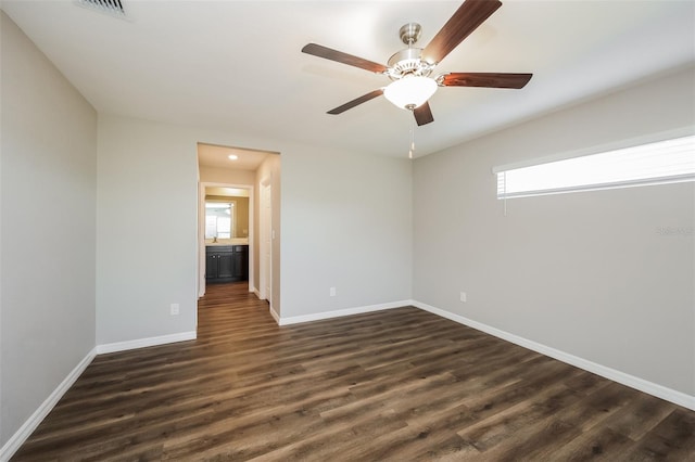 unfurnished room with ceiling fan and dark hardwood / wood-style floors