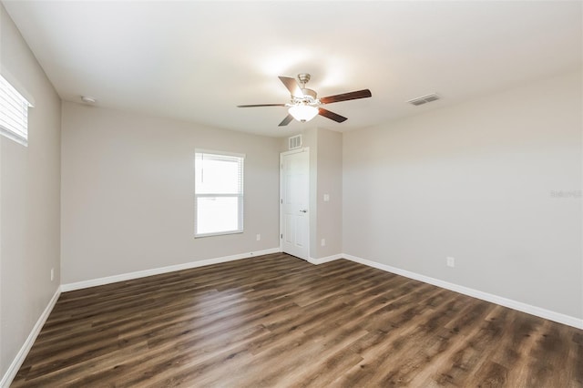 unfurnished room with ceiling fan, plenty of natural light, and dark hardwood / wood-style floors