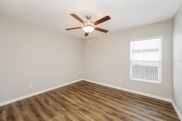 empty room with dark hardwood / wood-style floors and ceiling fan