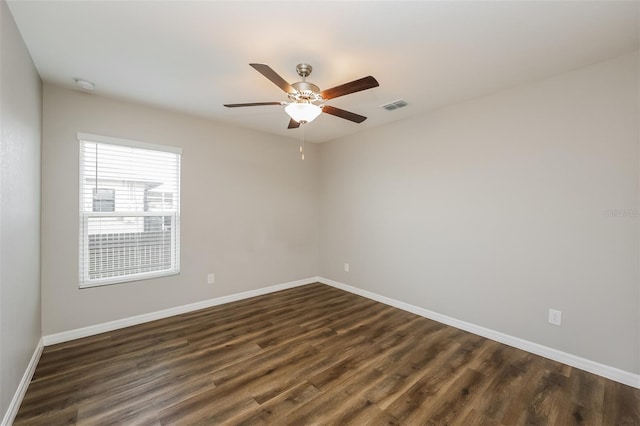 unfurnished room with ceiling fan and dark hardwood / wood-style flooring