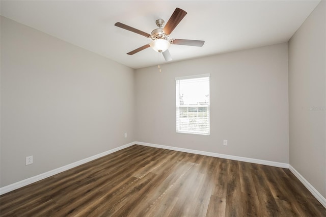 empty room with dark wood-type flooring and ceiling fan