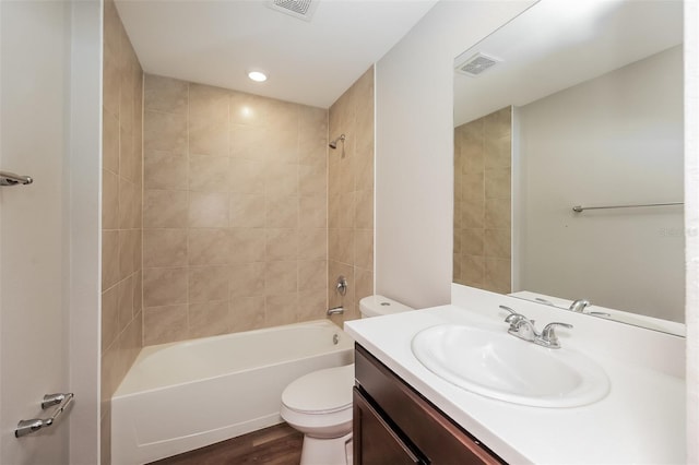 full bathroom with vanity, wood-type flooring, toilet, and tiled shower / bath