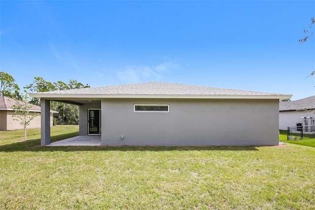 rear view of property featuring a yard and a patio