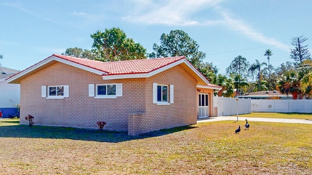 view of side of home featuring a yard