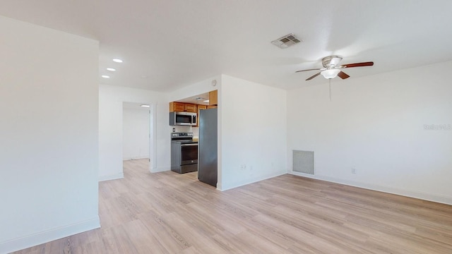 spare room featuring light hardwood / wood-style floors and ceiling fan