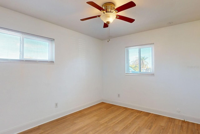 empty room with ceiling fan and light wood-type flooring