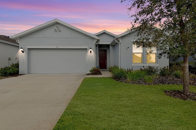 ranch-style home with a garage and a lawn