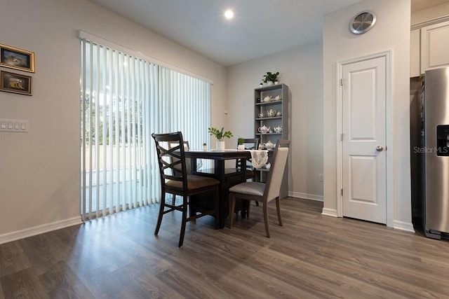 dining room with baseboards and dark wood-type flooring