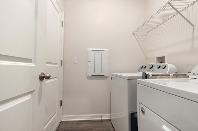 laundry room featuring baseboards, laundry area, washer and clothes dryer, and dark wood-style flooring