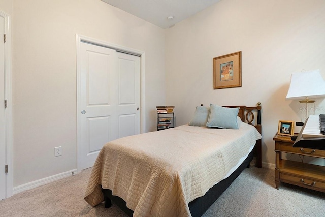 bedroom with a closet, baseboards, and carpet flooring