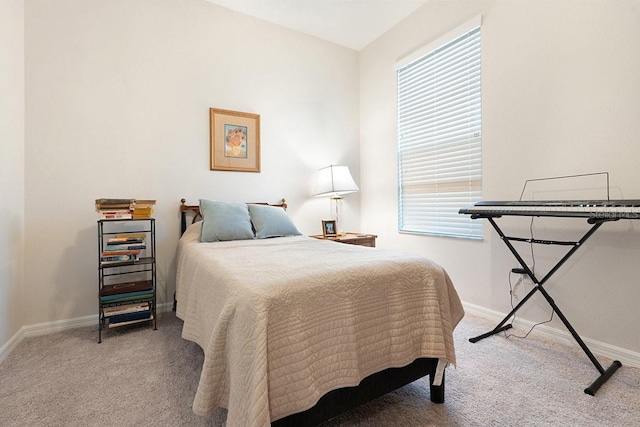 bedroom with carpet floors and baseboards