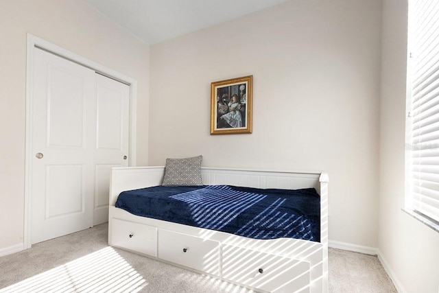 carpeted bedroom featuring baseboards