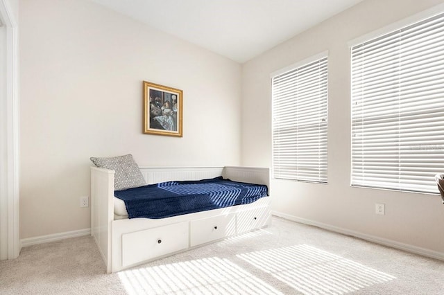 carpeted bedroom featuring baseboards