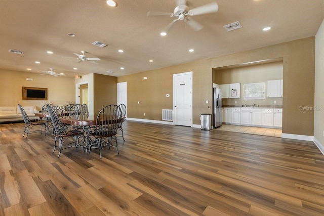 dining space featuring visible vents, wood finished floors, and recessed lighting