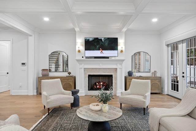 living room with french doors, coffered ceiling, light hardwood / wood-style floors, and beamed ceiling