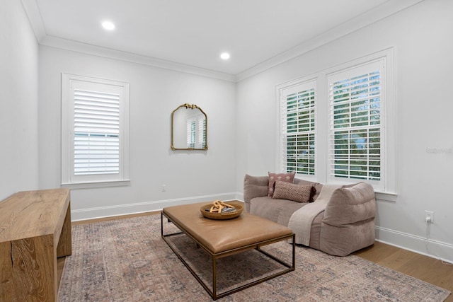 living room with hardwood / wood-style flooring and ornamental molding