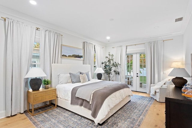 bedroom with access to outside, ornamental molding, french doors, and light wood-type flooring