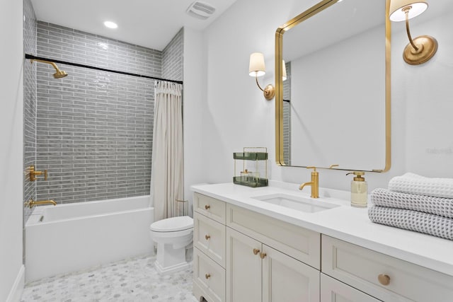 full bathroom featuring vanity, shower / tub combo, and toilet