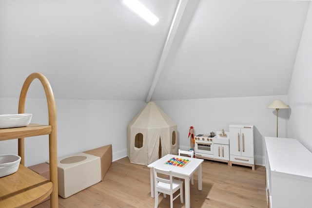 game room with lofted ceiling and light hardwood / wood-style flooring