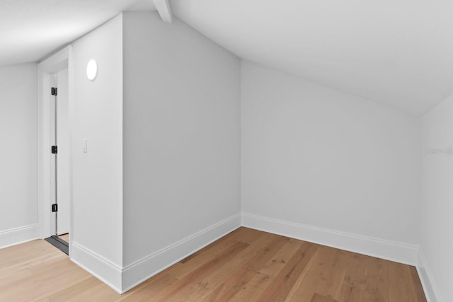 bonus room with hardwood / wood-style flooring and vaulted ceiling