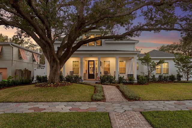 view of front of house featuring a porch and a yard