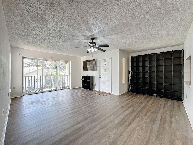 unfurnished living room with hardwood / wood-style floors and ceiling fan